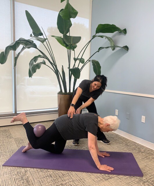 Therapist and resident doing a pilates work out